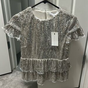 XS endless rose champagne pepulum top.